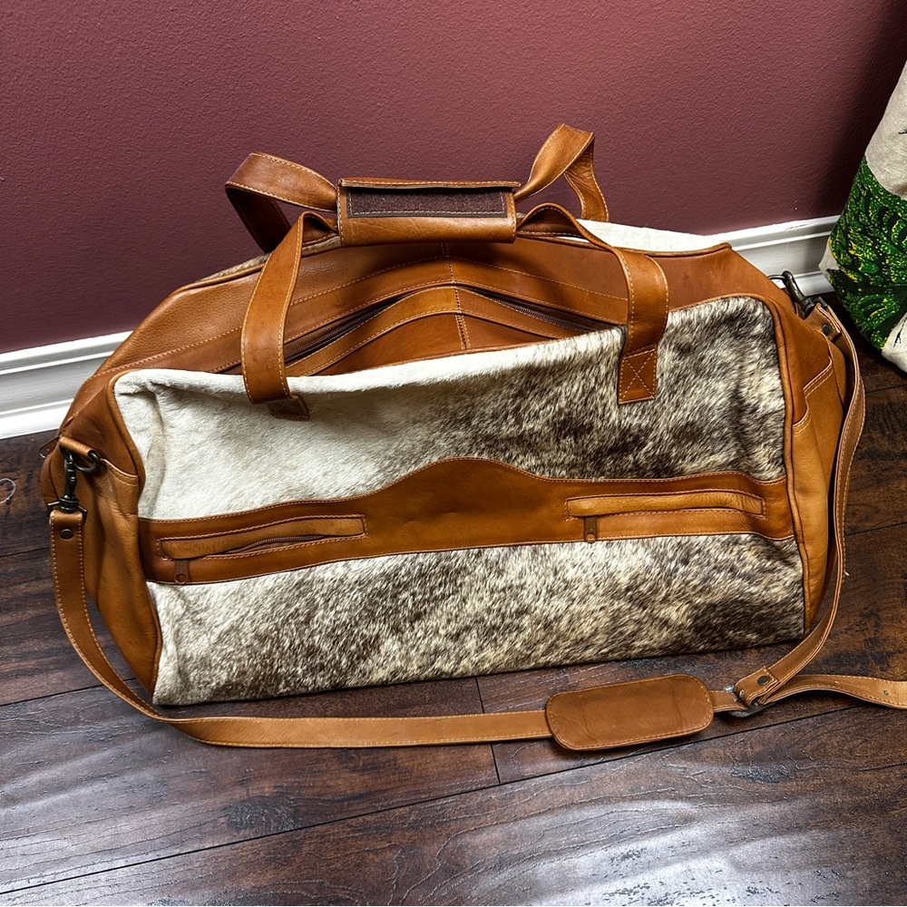 Cowhide and brown leather duffle bag with shoulder strap